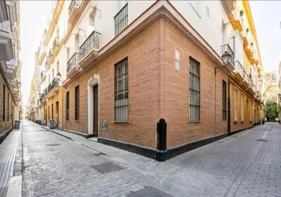 a brick building on the side of a street at Apartamento luminoso y céntrico in Cádiz