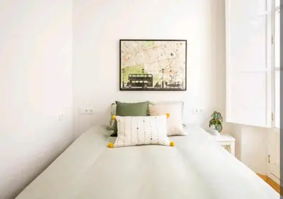 a white bedroom with a large bed in a room at Apartamento luminoso y céntrico in Cádiz