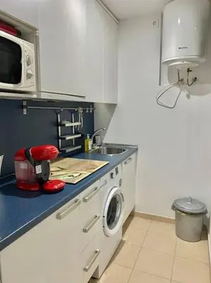 a kitchen with a sink and a washing machine at Apartamento nuevo con piscina, temporada in El Puerto de Santa María