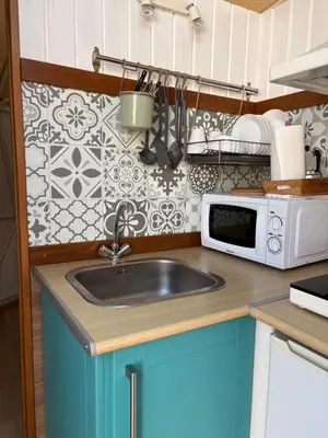 a kitchen with a sink and a microwave at ADAMA Glamping in Chiclana de la Frontera