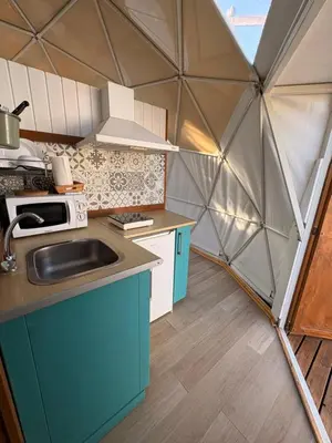 a kitchen in a dome tent with a sink at ADAMA Glamping in Chiclana de la Frontera