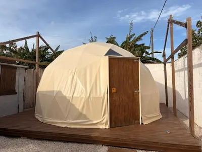 a large tent sitting on a wooden deck at ADAMA Glamping in Chiclana de la Frontera