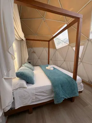 a bedroom with a canopy bed in a tent at ADAMA Glamping in Chiclana de la Frontera
