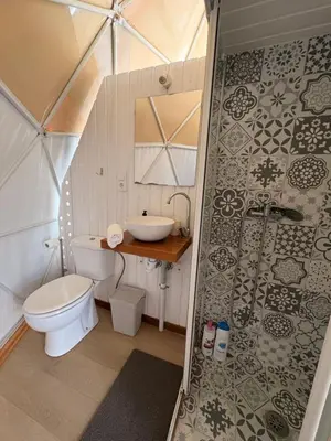 a bathroom with a toilet and a sink in a tent at ADAMA Glamping in Chiclana de la Frontera