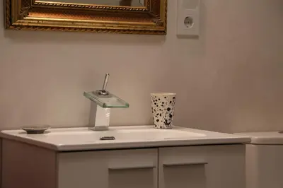 a bathroom with a sink and a mirror at Casa de la Fra in Jerez de la Frontera