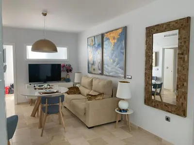 a living room with a couch and a table at Coral Oro en la Caleta Ha Apartment in Cádiz