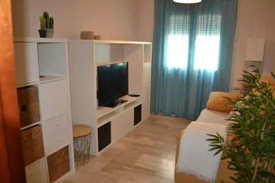 a living room with a couch and a television at Apartamento Posidonia Free Parking in Cádiz