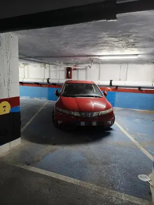 a red car parked in a parking garage at Apartamento Posidonia Free Parking in Cádiz