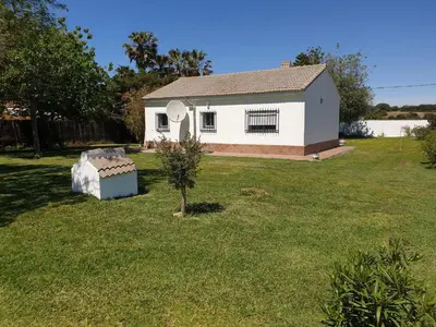 a house with a small tree in a yard at Casa Francesca, 90 m2, jardin de 1500m2 in Hozanejos
