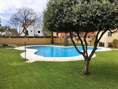 a swimming pool in a yard with a tree at La Alcazaba de Cristina in El Puerto de Santa María