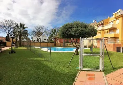 a park with a swing set in the grass at La Alcazaba de Cristina in El Puerto de Santa María