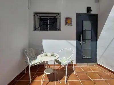 a table and chairs in a room with a door at Estudio 