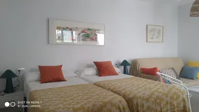 a living room with two beds and a couch at Estudio 