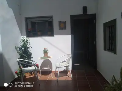 a patio with two chairs and a table and a door at Estudio 