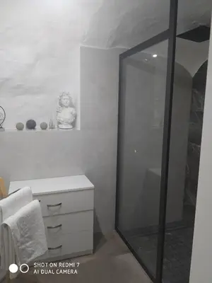 a bathroom with a glass shower and a white cabinet at Estudio 