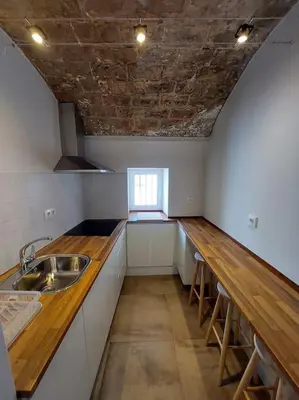 a kitchen with a sink and a wooden counter top at Estudio 