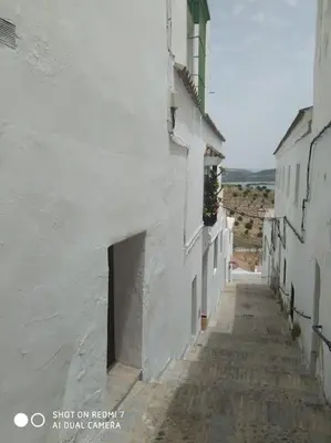 an alley with a white building and a street at Estudio 
