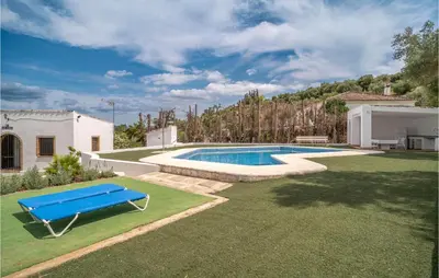 a pool with a blue bench in a yard at Pet Friendly Home In Algar in Algar