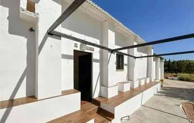 a white building with a door and a balcony at Pet Friendly Home In Algar in Algar