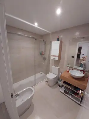 a bathroom with a toilet and a sink and a shower at Torre D'Arenas, playa Victoria, piscina y parking in Cádiz