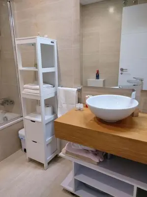 a bathroom with a white sink and a mirror at Torre D'Arenas, playa Victoria, piscina y parking in Cádiz