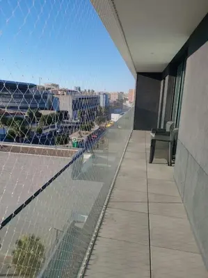 a balcony of a building with a view of a city at Torre D'Arenas, playa Victoria, piscina y parking in Cádiz