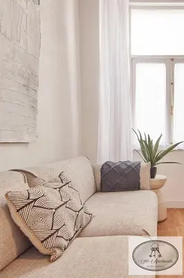 a living room with a couch and a window at La Linda Little Apartments in Cádiz