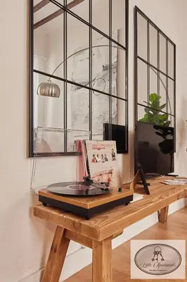 a wooden table with a book on top of it at La Linda Little Apartments in Cádiz