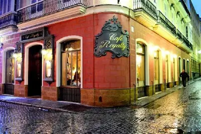 a person walking down a street in front of a store at La Linda Little Apartments in Cádiz