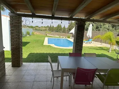 a patio with a table and chairs and a pool at Casa Sampalo in Cádiz