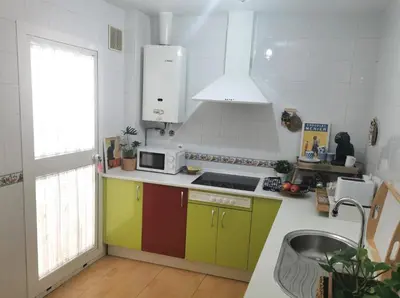 a kitchen with colorful cabinets and a sink at Apartamento Pirrado in Sanlúcar de Barrameda