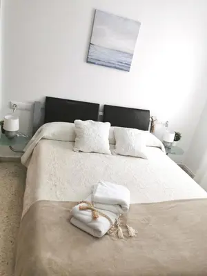 a bedroom with a bed with two towels on it at Apartamento Pirrado in Sanlúcar de Barrameda