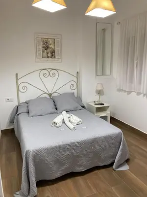 a bedroom with a bed with two towels on it at Apartamento Peña de Hita in El Puerto de Santa María