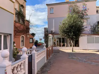 a white fence in front of a building at Apartamento Peña de Hita in El Puerto de Santa María
