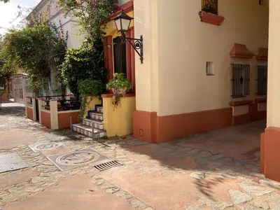 a building with stairs and plants on the side of it at Apartamento Peña de Hita in El Puerto de Santa María