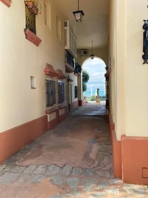 an empty alley in a building with an archway at Apartamento Peña de Hita in El Puerto de Santa María