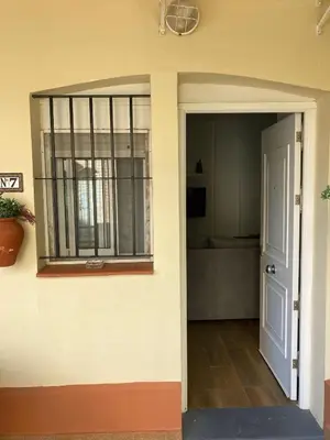 an open door of a house with a balcony at Apartamento Peña de Hita in El Puerto de Santa María