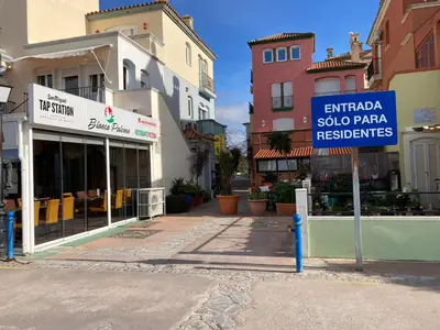 a sign in the middle of a street with buildings at Apartamento Peña de Hita in El Puerto de Santa María