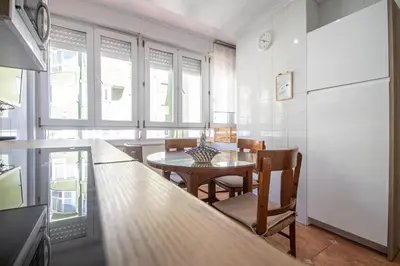 a kitchen with a table and a dining room at Apartamento El descanso de Julia Augusta - Cadiz in Cádiz
