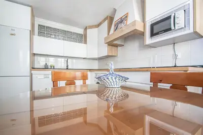 a kitchen with a table with a vase on it at Apartamento El descanso de Julia Augusta - Cadiz in Cádiz