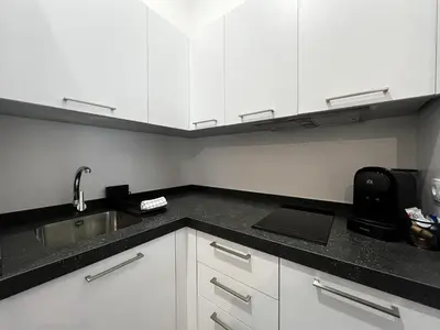 a kitchen with white cabinets and a sink at Kadis-Korazon Grupo AC Gestion in Cádiz