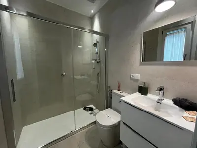 a bathroom with a shower and a toilet and a sink at Kadis-Korazon Grupo AC Gestion in Cádiz