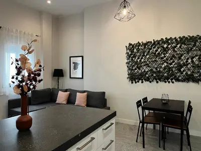 a living room with a couch and a table at Kadis-Korazon Grupo AC Gestion in Cádiz