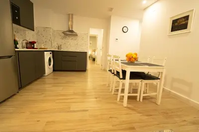 a kitchen and dining room with a table and chairs at Apartamentos Consistorio Live in Jerez de la Frontera