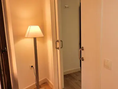 a lamp in a room next to a door at Apartamentos Consistorio Live in Jerez de la Frontera
