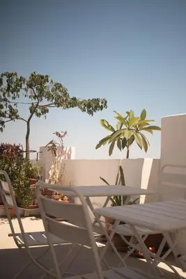 a pair of chairs and a table on a patio at Botánico Casa Rural in Arcos de la Frontera