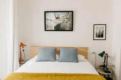 a bedroom with a large white bed with two pillows at Botánico Casa Rural in Arcos de la Frontera