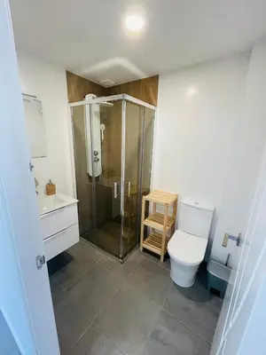 a bathroom with a shower and a toilet and a sink at Duplex ático Bajo de Guía in Sanlúcar de Barrameda