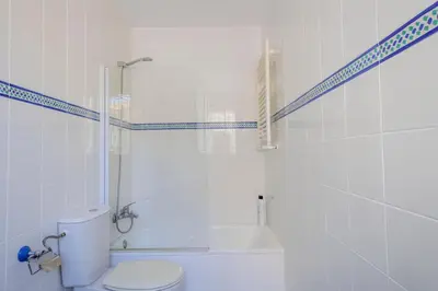 a bathroom with a toilet and a shower and a tub at GINVA - Villa Puerto Sherry in El Puerto de Santa María