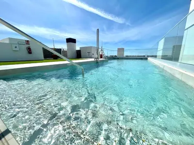 a swimming pool on the roof of a building at GATU PREMIUM Sandia Beach lujo junto al mar, parking y piscina común,